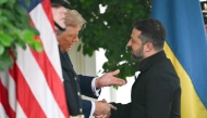 Ukrainian President Volodymyr Zelensky is greeted by US President Donald Trump (left) upon arrival at the White House West Wing in Washington, DC, on August 18, 2025. (Photo by Andrew Caballero-Reynolds / AFP)