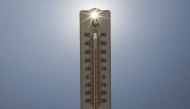 This photograph shows sun rays shining through a handheld house thermometer reading 35 degrees Celsius, in Montreuil on the afternoon of August 14, 2025, amid a heatwave in Europe. Photo by Martin LELIEVRE / AFP.