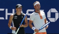 Poland's Iga Swiatek and Norway's Casper Ruud after a point against Madison Keys and Frances Tiafoe of the USA during their Mixed Doubles Match at the US Open tennis tournament at the USTA Billie Jean King National Tennis Center in New York City, on August 19, 2025. (Photo by Timothy A. Clary / AFP)