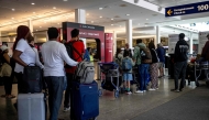 Passengers queue to check in as Air Canada flights are slated to resume as early as this evening at Pierre-Elliott Trudeau Airport in Montreal, Quebec, on August 19, 2025.  (Photo by Andrej Ivanov / AFP)