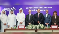 Officials during the partnership ceremony at Commercial Bank Qatar headquarters.