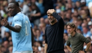 Manchester City's Spanish manager Pep Guardiola (C) and Tottenham Hotspur's Danish head coach Thomas Frank (R) react during the English Premier League football match between Manchester City and Tottenham Hotspur at the Etihad Stadium in Manchester, north west England, on August 23, 2025. (Photo by Darren Staples / AFP) /