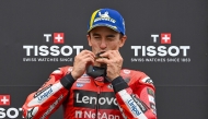 Ducati Lenovo Team's Spanish rider Marc Marquez kisses his gold medal as he celebrates his victory after the sprint race ahead of the motorcycle Hungarian Moto GP Grand Prix at the Balaton Park circuit in Balatonfokajar, Hungary, on August 23, 2025. (Photo by ATTILA KISBENEDEK / AFP)