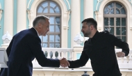 Ukrainian President Volodymyr Zelensky (right) and Canadian Prime Minister Mark Carney shake hands during their press-conference following the talks outside Mariyinsky Palace in Kyiv on August 24, 2025. (Photo by Sergei Supinsky / AFP)
