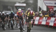 Team Visma-Lease a bike's Danish rider Jonas Vingegaard (R) crosses the finish line during the second stage of the Vuelta a Espana on August 24, 2025. (Photo by Marco Bertorello / AFP)