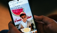 Almadhoun checks out the scene from Gaza using WhatsApp on July 17. Photo credit: Maxine Wallace/The Washington Post
