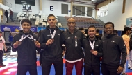 Qatari athletes pose with their medals.