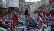 File: People holding placards and flags of Palestine take part in a 'March For Palestine', part of a pro-Palestinian national demonstration, in London on October 14, 2023. (Photo by Adrian Dennis / AFP)

