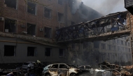 File: Burned cars are seen outside a destroyed building following Russian shelling, as Russia's attack on Ukraine continues, in Kharkiv, Ukraine, April 16, 2022 / Reuters photo on file