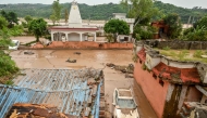 A damaged car is pictured under mud and debris after heavy rains induced flood in Jammu on August 27, 2025. Photo by AFP