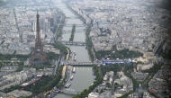 A photograph taken from an helicopter on July 26, 2024 shows an aerial view of the Eiffel Tower along the Seine river during the opening ceremony of the Paris 2024 Olympic Games in Paris. (Photo by Lionel BONAVENTURE / POOL / AFP)

