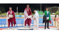 Younis Al Balushi receives a certificate from Qatar Athletics Federation President Mohammed Issa Al-Fadala after winning pole vault gold. 