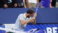 Russia's Daniil Medvedev breaks his racket after losing his men's singles first round tennis match against France’s Benjamin Bonzi on day one of the US Open tennis tournament at the USTA Billie Jean King National Tennis Center in New York City, on August 24, 2025. (Photo by CHARLY TRIBALLEAU / AFP)
