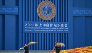 Cleaning staff work in front of the Meijiang Convention and Exhibition Center ahead of the Shanghai Cooperation Organisation (SCO) Summit in Tianjin on August 30, 2025. (Photo by Pedro Pardo / AFP)
