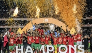 Morocco's defender #24 Mohamed Rabie Hrimat holds the trophy as Morocco celebrates winning the African Nations Championship (CHAN) final against Madagascar at Kasarani Stadium in Nairobi, on August 30, 2025. (Photo by Luis Tato / AFP)