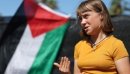Swedish climate activist Greta Thunberg gestures while talking to media next to a Palestinian flag as a flotilla carrying humanitarian aid and activists prepare to leave on August 30, 2025. (Photo by Lluis Gene / AFP)