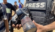 A journalist holds the blood-covered camera belonging to Palestinian photojournalist Mariam Dagga, a journalist who freelanced for AP since the start of the war and who was killed in an Israeli strike on Nasser hospital in Khan Yunis in the southern Gaza Strip. Photo by AFP