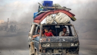 People ride a microbus carrying their belongings as they evacuate southbound from Gaza City on September 2, 2025. Photo by Eyad BABA / AFP