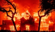 File: A home is engulfed in flames during the Eaton fire in the Altadena area of Los Angeles County, California on January 8, 2025. (Photo by Josh Edelson / AFP)