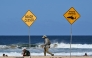 Residents walks along the shoreline as northern Sydney beaches are closed following a shark attack at Long Reef Beach on September 6, 2025. (Photo by Saeed Khand / AFP)