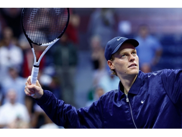 Italy's Jannik Sinner hits a ball to a fan after winning his men's singles semifinal tennis match against Canada's Felix Auger-Aliassime on September 5, 2025. (Photo by Kena Betancur / AFP)