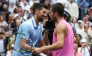Spain's Carlos Alcaraz and Serbia's Novak Djokovic (L) hug at the net after Alcaraz's victory on September 5, 2025. (Photo by Timothy A. Clary / AFP)
 