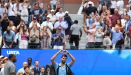 Novak Djokovic of Serbia acknowledges the crowd as he walks off the court after losing to Carlos Alcaraz of Spain on September 5, 2025. Clive Brunskill/Getty Images/AFP 
 