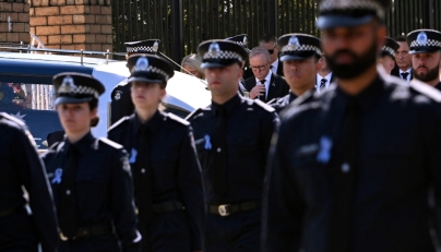 Australia's Prime Minister Anthony Albanese (C) pays his respects as the coffin of police officer Senior Constable Vadim de Waart-Hottart leaves the Victoria Police Academy chapel. (Photo by William West / AFP)