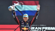 Red Bull Racing's Dutch driver Max Verstappen celebrates his victory on the podium after winning the Italian Formula One Grand Prix at the Autodromo Nazionale Monza circuit, in Monza, northern Italy, on September 7, 2025. (Photo by Marco Bertorello / AFP)