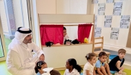 Assistant Undersecretary for Private Education Affairs at the Ministry of Education and Higher Education Omar Abdulaziz Al-Naama with some students during a visit.