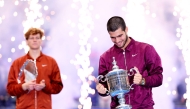 Carlos Alcaraz of Spain poses with his trophy after defeating Jannik Sinner of Italy during their Men's Singles Final match on Day Fifteen of the 2025 US Open at USTA Billie Jean King National Tennis Center on September 07, 2025 in New York City. Clive Brunskill/Getty Images/AFP
