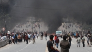 A fire burns as demonstrators gather on a road during a protest to condemn the police's deadly crackdown on demonstrators in Kathmandu on September 9, 2025. (Photo by Prabin Ranabhat / AFP)