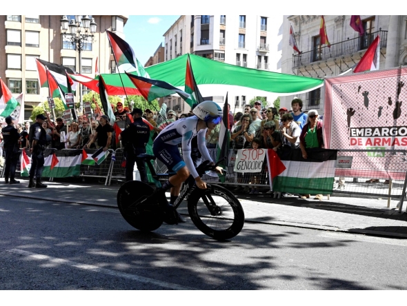 Pro-Palestinians protesters demonstrate as a cyclist competes during the 18th stage of the Vuelta a Espana, yesterday. 