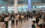 South Korean workers arrive at Incheon International Airport in Incheon on September 12, 2025, after the touch down of a specially chartered Korean Air Boeing 747-81 (KE9036) bringing hundreds of South Korean workers back from Atlanta after their detention in a US immigration raid at a Hyundai-LG plant in Ellabell, Georgia. (Photo by Anthony WALLACE / AFP)