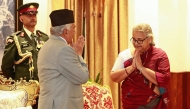 Nepal's President Ram Chandra Paudel gestures after administering the oath to the country's newly appointed Prime Minister Sushila Karki during her swearing-in-ceremony at the President House in Kathmandu on September 12, 2025. (Photo by Sujan Gurung / AFP)
 