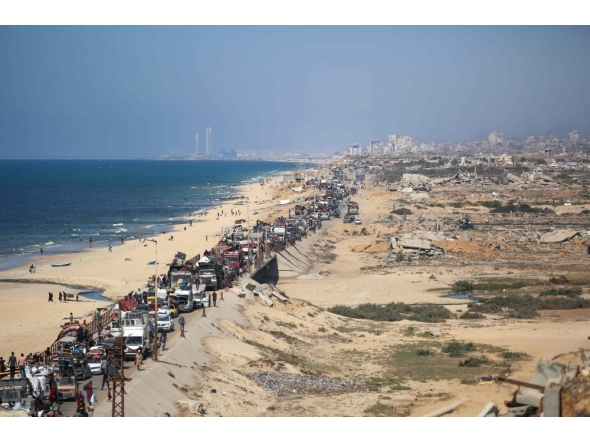 Displaced Palestinians move with their belongings southwards on a road in the Nuseirat refugee camp area in the central Gaza Strip following renewed Israeli evacuation orders for Gaza City on September 14, 2025. (Photo by Eyad Baba / AFP)
