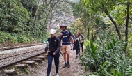 A group of tourists leaves on foot due to a protest by residents in Machu Picchu Pueblo, Peru, on September 16, 2025. (Photo by Carolina Paucar / AFP)
