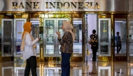 Employees talk in the lobby of Bank Indonesia, the country's central bank, in Jakarta on September 16, 2025. (Photo by Bay Ismoyo / AFP)
