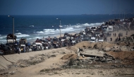 Palestinians from Gaza City move southwards with their belongings, on the coastal road near the Nuseirat refugee camp in the central Gaza Strip, on September 19, 2025. (Photo by Eyad Baba / AFP)