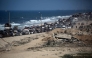 Palestinians from Gaza City move southwards with their belongings, on the coastal road near the Nuseirat refugee camp in the central Gaza Strip, on September 19, 2025. (Photo by Eyad Baba / AFP)