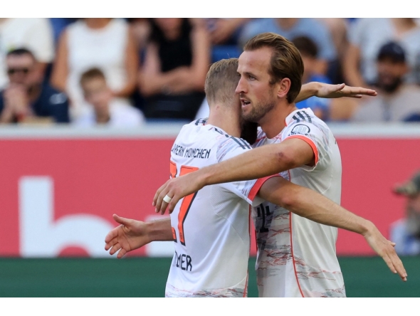 Bayern Munich's English forward #09 Harry Kane (R) celebrates with team mate Bayern Munich's Austrian midfielder #27 Konrad Laimer after scoring his team's third goal during the German first division Bundesliga football match between TSG 1899 Hoffenheim and FC Bayern Munich in Sinsheim, southwestern Germany on September 20, 2025. (Photo by Daniel ROLAND / AFP)