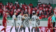 Al Duhail's Adil Boulbina (third left) celebrates with teammates.
