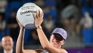 Iga Swiatek of Poland celebrates with the trophy after beating Ekaterina Alexandrova of Russia to win the women's singles final match at the Korea Open tennis tournament in Seoul on September 21, 2025. (Photo by Jung Yeon-je / AFP)