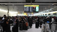 Travellers wait in terminal 4 at Heathrow Airport, west of London on September 20, 2025. Photo by JUSTIN TALLIS / AFP