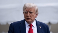 US President Donald Trump stops to speak with reporters while walking to Marine One on the South Lawn of the White House September 21, 2025, in Washington, DC. Trump is heading to Glendale, Arizona to attend the public memorial service for Charlie Kirk. (Photo by Brendan Smialowski / AFP)

