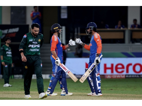 India's Abhishek Sharma and Tilak Varma bump fists during the Asia Cup 2025 Super Four Twenty20 international cricket match between India and Pakistan at the Dubai International Stadium in Dubai on September 21, 2025. (Photo by Fadel SENNA / AFP)
