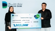 Dukhan Bank official with Thara'a grand prize winner.