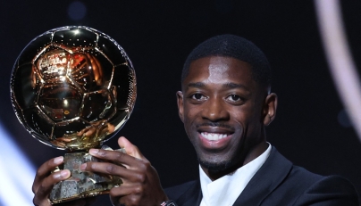 Paris Saint-Germain's French forward Ousmane Dembele reacts receiving the Ballon d'Or award during the 2025 Ballon d'Or France Football award ceremony at the Theatre du Chatelet in Paris on September 22, 2025. (Photo by Franck FIFE / AFP)
