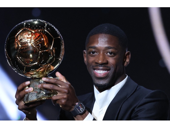 Paris Saint-Germain's French forward Ousmane Dembele reacts receiving the Ballon d'Or award during the 2025 Ballon d'Or France Football award ceremony at the Theatre du Chatelet in Paris on September 22, 2025. (Photo by Franck FIFE / AFP)
