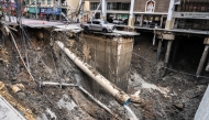 A vehicle is seen on the edge of a hole in the ground after a road collapsed near a hospital in Bangkok on September 24, 2025. (Photo by Chanakarn Laosarakham / AFP)